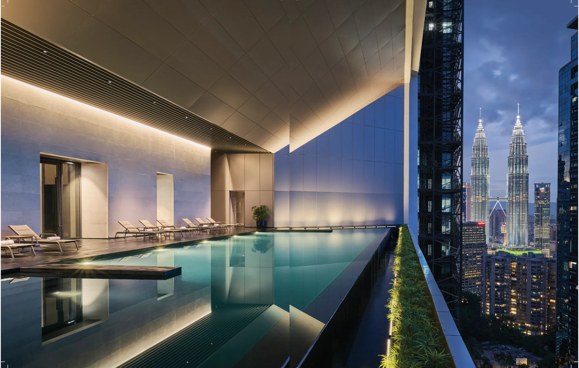 Conlay Signature Suites indoor infinity pool with Petronas Twin Towers view